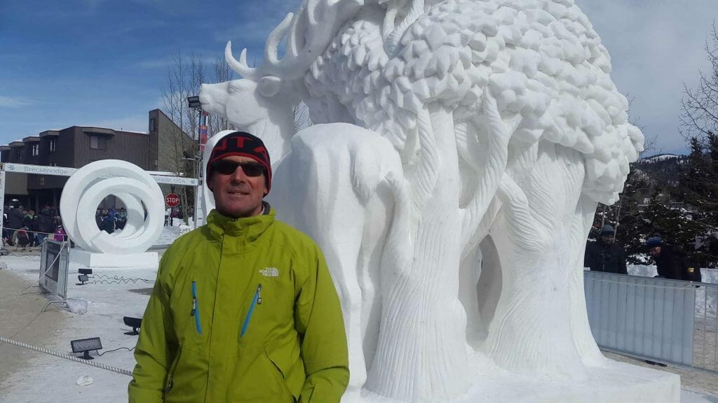 Peter standing next to snow sculpture