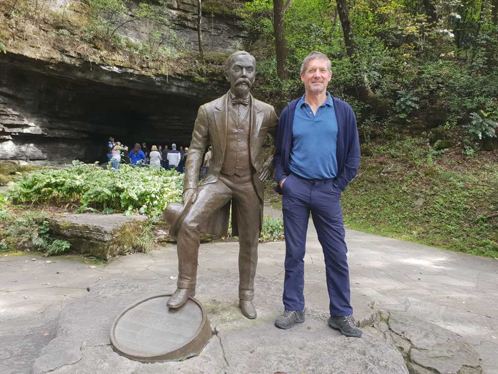 Peter standing with statue of Jack Daniel