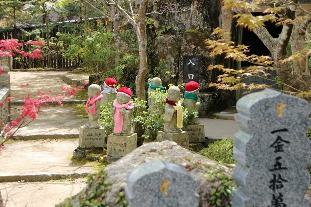 Jizo figures in hats and scarves
