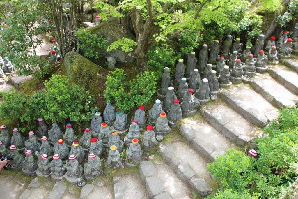 Jizo figures wearing hats and scarves