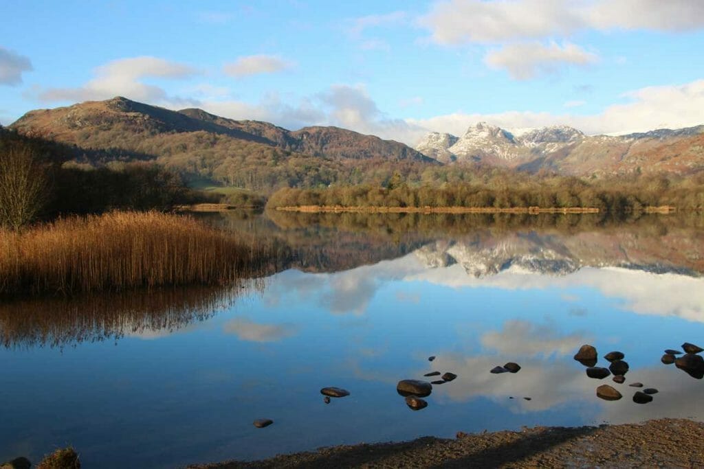 Reflection on Elter Water with view over Langdales 