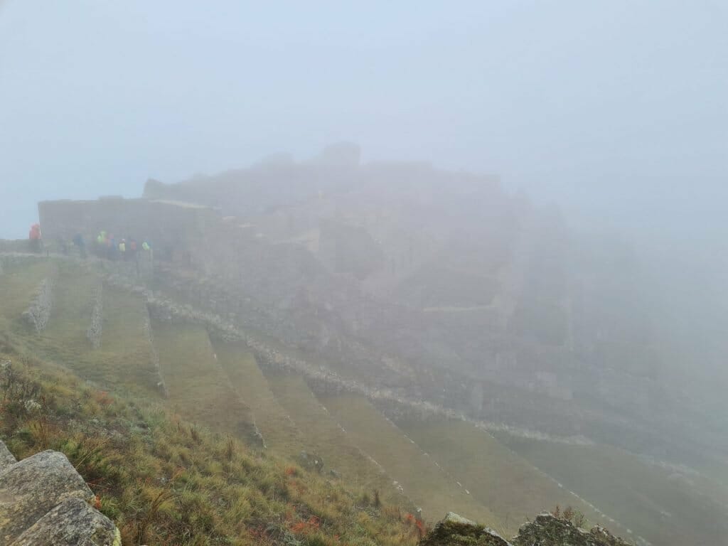 Foggy scene with barely discernable Machu Picchu in background