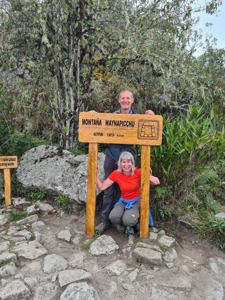 Jane and Peter by Wayna Picchu sign at top of climb