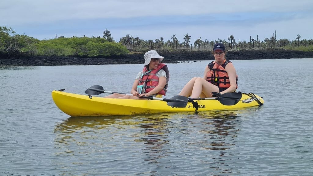Two girls in kayak at Tortuga Bay on trip to the Galapagos Islands