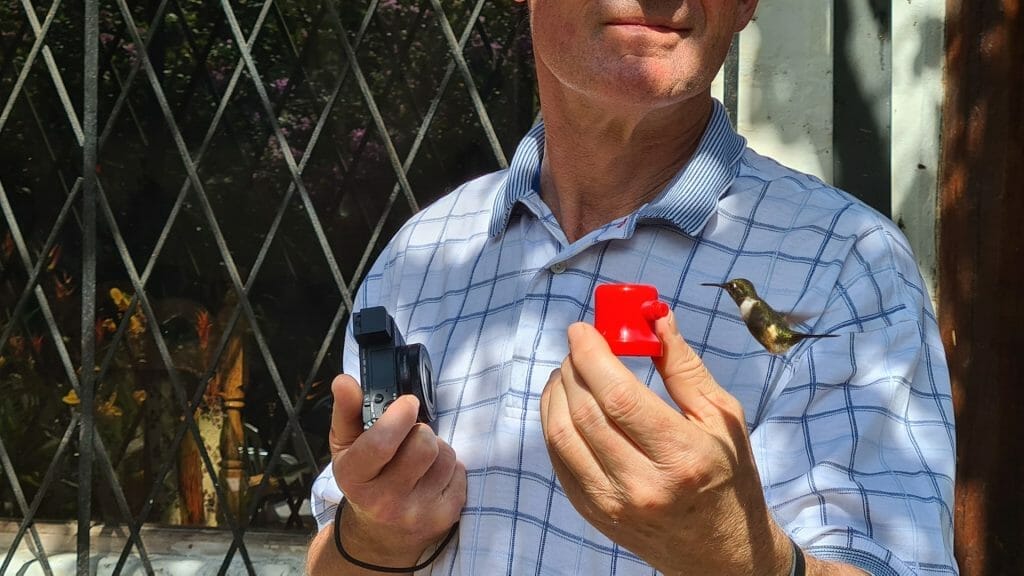 Peter holding container and humming bird in close