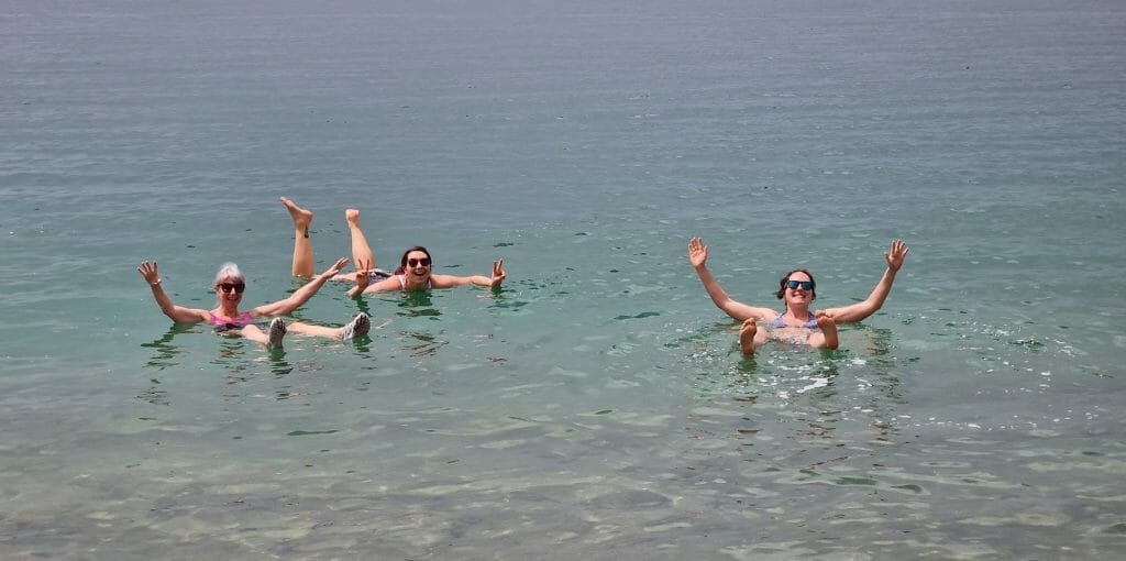 Three girls enjoying swimming in the Dead Sea