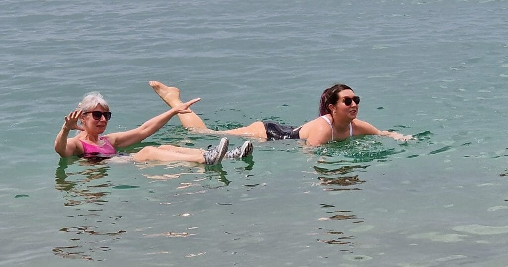 Jane floating and Beth swimming in the Dead Sea