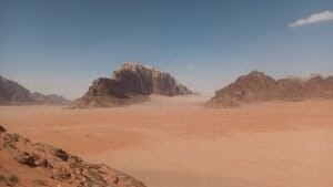 Red, sandy desert with rocky mountains on a Wadi Rum visit