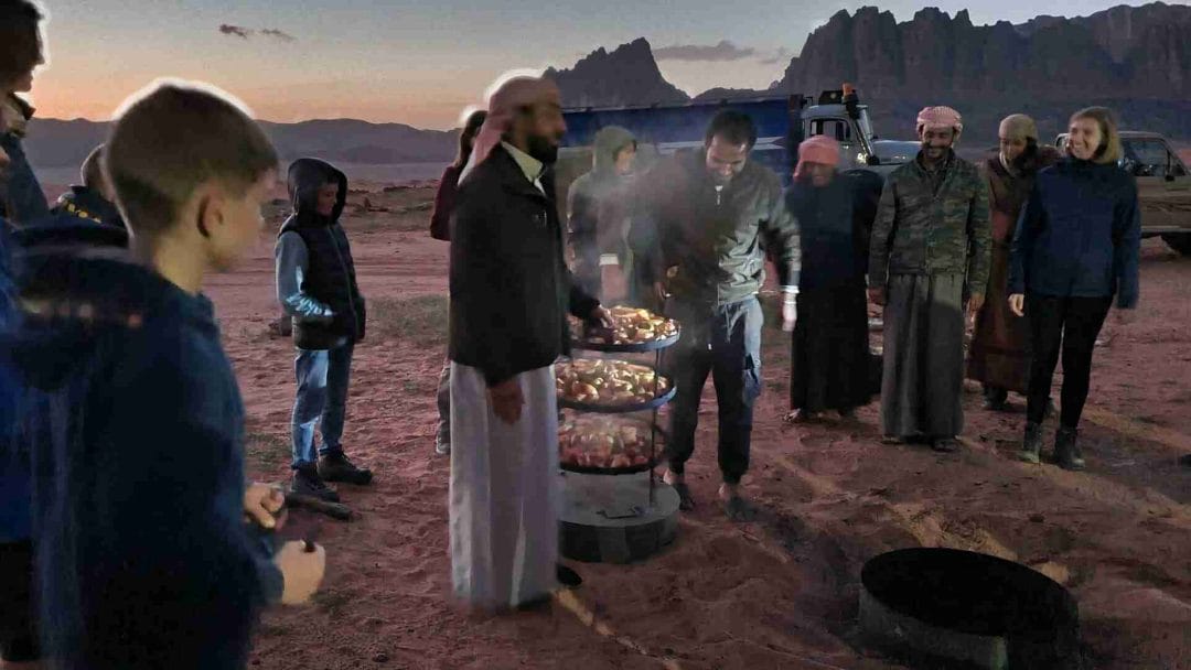 Taking the food from the ground in the Bedouin camp in Wadi Rum