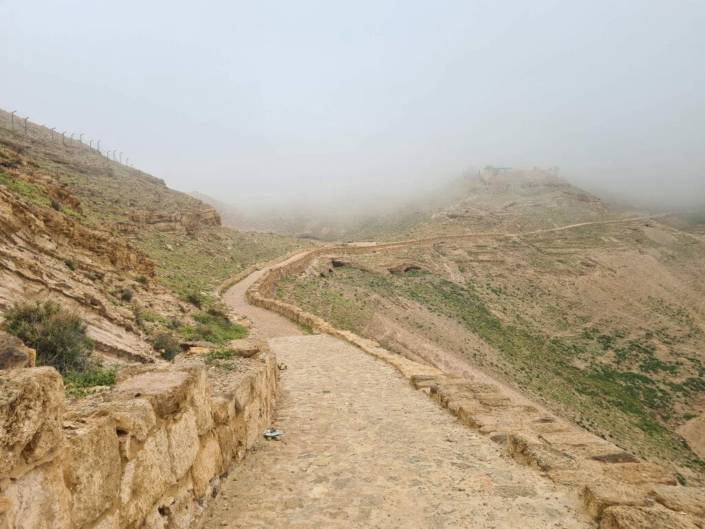 Gravel path leading into fog